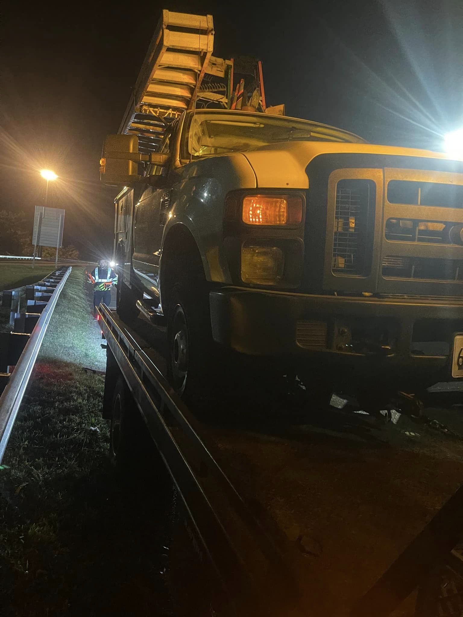 Pickup truck being secured to a flatbed tow truck